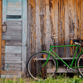 Old wooden wall and green bicycle Old wooden wall and green bicycle